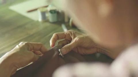 Slow motion  a hand of a  tailor who sews with a needle and thread Stock Footage 75951709