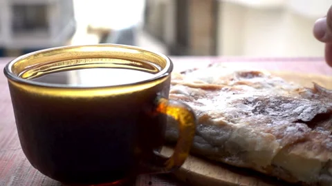 Slow motion hand takes a piece of cake and cup of coffee. Stock Footage 112933865
