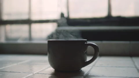 Slow Motion Hand Taking Steaming Cup of Tea by Window Light Stock-Footage 320063088