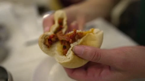 Slow motion hand tears open cha siu bao pork bun dim sum Stock Footage 169243322