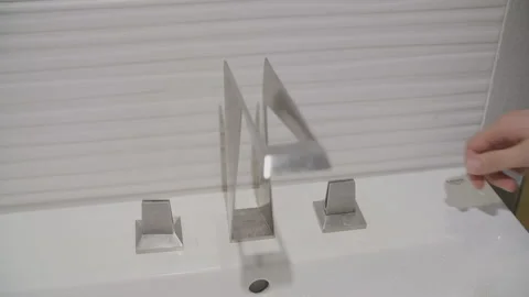 Slow motion of hand turn on/off chrome faucet Stock Footage 133130077