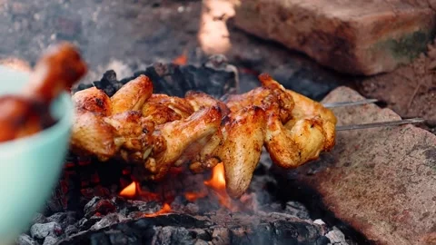 Slow Motion of Hand Turning Chicken Skewers Over Flames Stock Footage 303006064