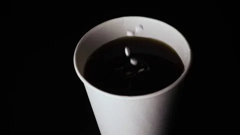 Slow motion. A handful of sugar substitutes drops into a glass Video stock 74267810