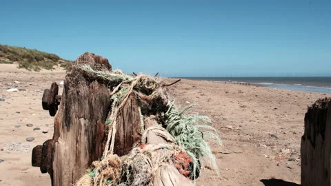 Slow motion handheld clip of some weathered wooden pillars and old ropes Stock-Footage 135845221