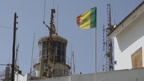 Slow Motion Handheld Senegal Flag Waving Mamelles Lighthouse Dakar Vidéo 336346576