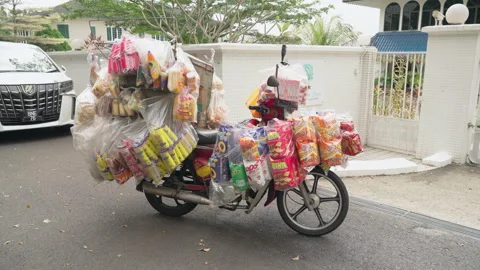 Slow motion handheld shot of a motorcycle packed with dozens of bread and Stock Footage 328565401