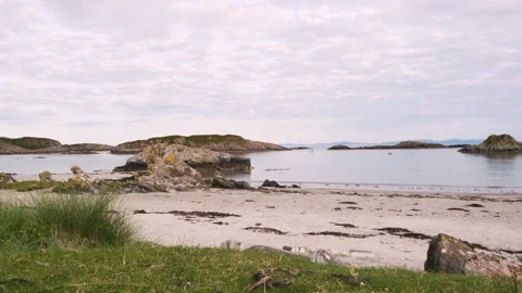 Slow motion handheld shot overlooking Uisken Beach at sunset in Mull, Scotland Stock Footage 138410389