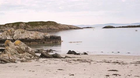 Slow motion handheld shot overlooking Uisken Beach at sunset in Mull, Scotland Stock Footage 138410505
