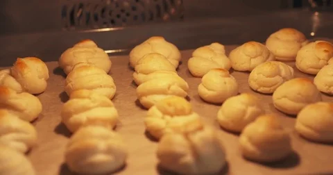 Slow motion handheld shot of profiteroles in oven Stock Footage