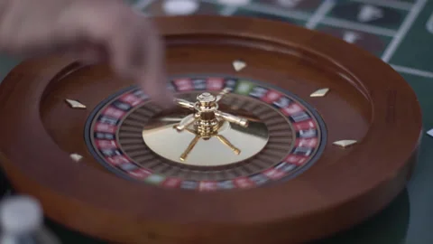 Slow-Motion Handheld Shot of a Roulette Wheel Being Spun and Ball Rolled Stock Footage 316562112