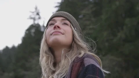 Slow motion handheld shot of young caucasian woman enjoying nature on cloudy day Stock Footage 208749373