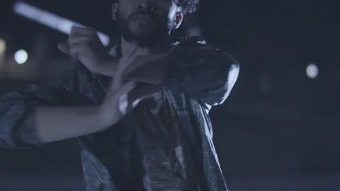 Slow motion handheld shot of young islamic boy dancing with hands during night Stock Footage 211869627