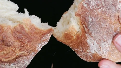 Slow motion of hands breaking a freshly baked loaf of bread Stock Footage 78196393