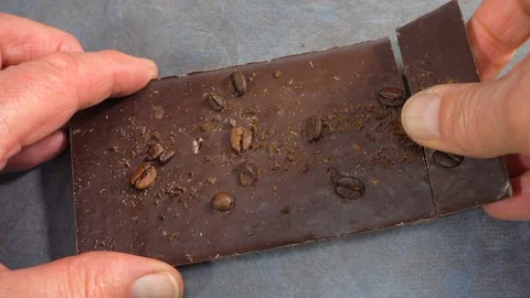 Slow motion – Hands breaking off a piece of chocolate bar. Stock Footage 119592002