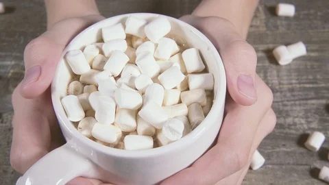 Slow motion in the hands of a Cup with a drink and marshmallows close-up Stock Footage 95394772