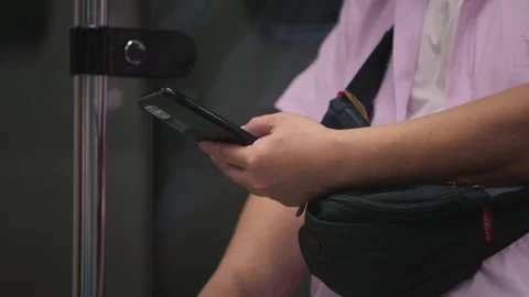 Slow motion of hands holding smartphone in Taipei metro Stock Footage 314677590