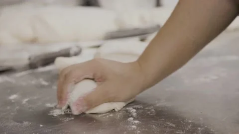 Slow motion hands kneading dough, bread, baker, flour table. 4K 24FPS Stock Footage 162144152