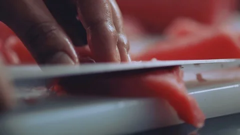 Slow motion hands man chef cuts raw meat with the knife in kitchen cooking Stock Footage 100303034