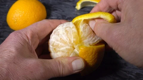 Slow motion - Hands peeling an orange. Stock Footage 119767342