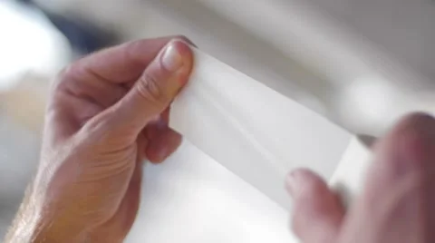 Slow motion of hands using paper tape Stock Footage 51734826