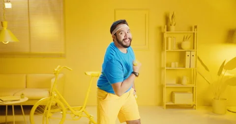 Slow motion of handsome young guy workout with dumbbell while smiling and Video stock 165863988