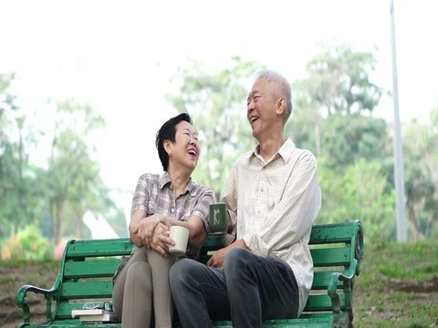 Slow motion happy Asian senior couple drinking coffee Having conversation Stock Footage