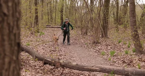 Slow motion a happy boy is running happily with his dog in forest Stock-Footage 153275883
