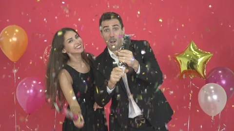 Slow motion - Happy couples with New Year's decorations and red backgrounds. Stock Footage 121131964