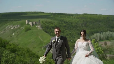 Slow motion. Happy man and woman having fun, turning around. Top on the hill Stock Footage 243660910
