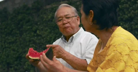 Slow motion of happy senior couple eat watermelon, smiled and relaxed Video stock 136011237