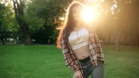 Slow motion of happy young dark-haired woman in wireless headphones dancing Stock Footage 199099057