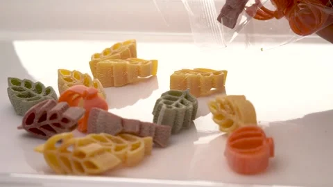 Slow motion Harvest Pasta Dropping Into Tray Video stock 217870830