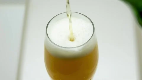 Slow Motion HD: Pouring Cold Beer into Glass Close-up 動画素材 334693634