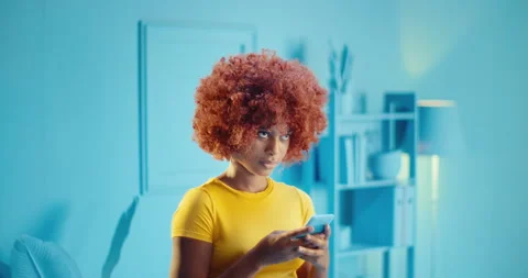 Slow motion headshot of disappointed young black woman using mobile phone and Video stock 164380690