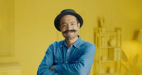 Slow motion headshot of Hispanic young man with a mustache and arms crossed Stock Footage 171372903