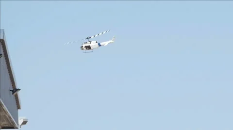 Slow Motion Helicopter Flies Over Hangar. Stock Footage 60847342