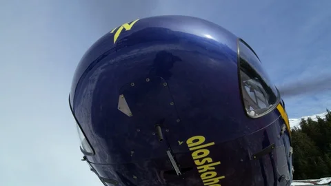 Slow motion of helicopter taking off from ski resort on sunny day Stock Footage 129109884