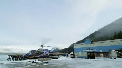 Slow motion of helicopter waiting before taking off from ski resort Video stock 129110294