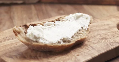 Slow motion of herbs falling on rustic bread with ricotta cheese Stock Footage 74524298