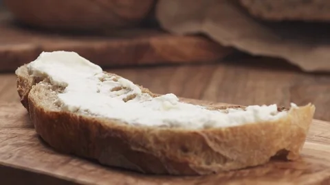 Slow motion of herbs falling on rustic bread with butter Stock Footage 78128799