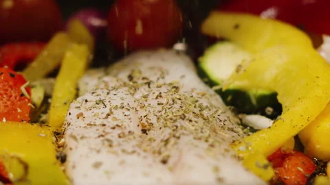 Slow motion herbs falling onto wild caught atlantic Cod fillets with Stock Footage 328680232