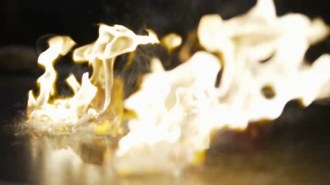 Slow motion hibachi chef sets grill on fire Stock Footage 162082487
