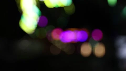Slow motion highly defocused light balls midway rides and lights at night Stock Footage 155414821