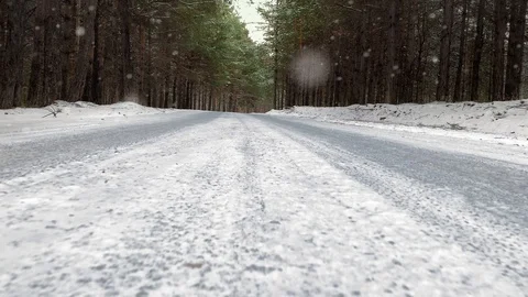 Slow motion. Highway on snow covered road in a winter forest. Mysterious winter Video stock 119080745