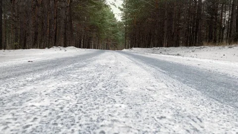 Slow motion. Highway on snow covered road in a winter forest. Mysterious winter  스톡 동영상 119080785