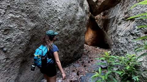 Slow motion hiker walking through a passageway of large rocks, Fasnia, Tenerife Stock Footage 172081232