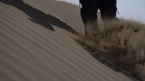 Slow Motion of Hiker Walking Through Thick Desert Sand and Falling 動画素材 318874193