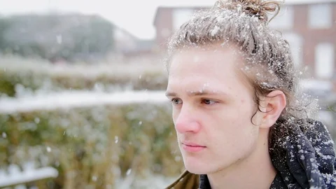 Slow motion hipster man standing in a snowy storm, staring intensely  Stock Footage 85696089