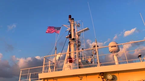 Slow motion of hoisted USA flag on top cargo vessel Stock Footage 242827688