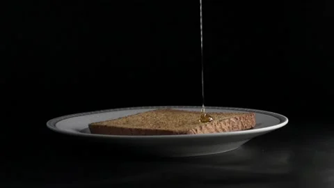 Slow motion honey drip on warm, toasted bread Stock Footage 138826085